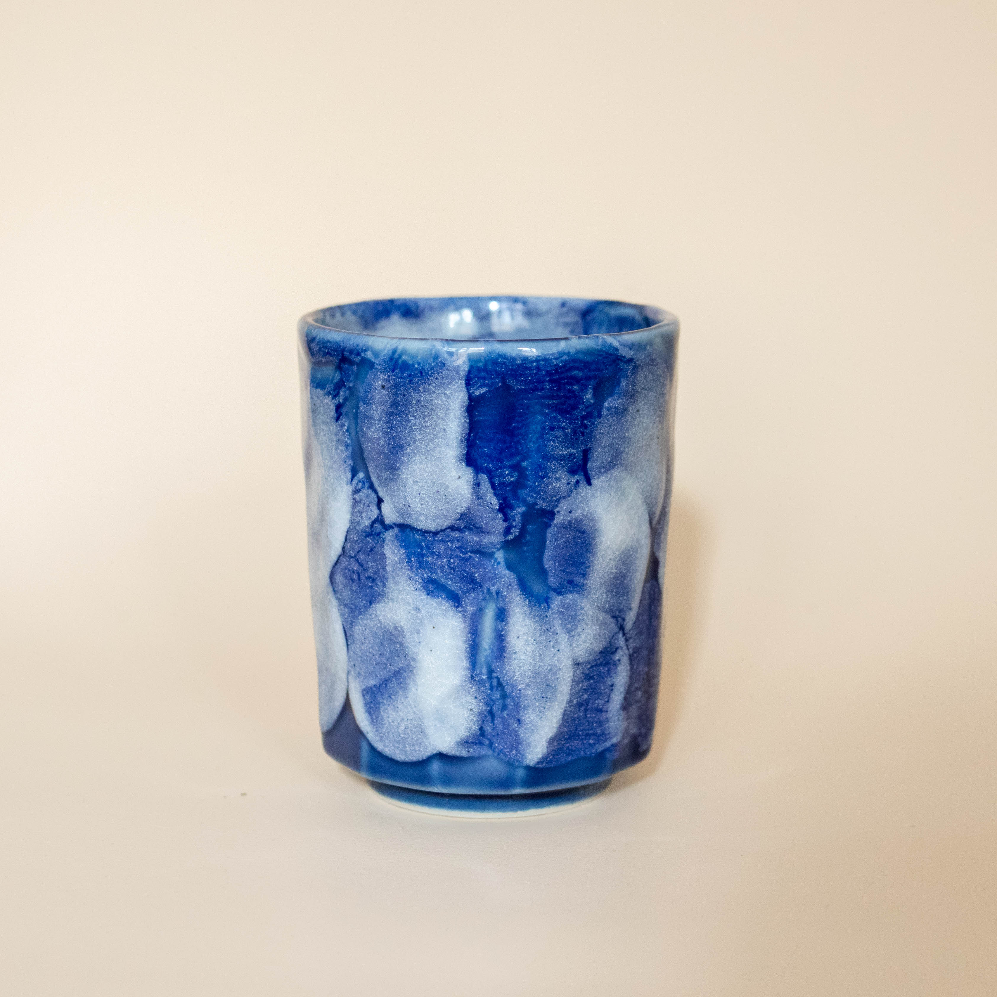 Ceramic cup with blue glaze and white details