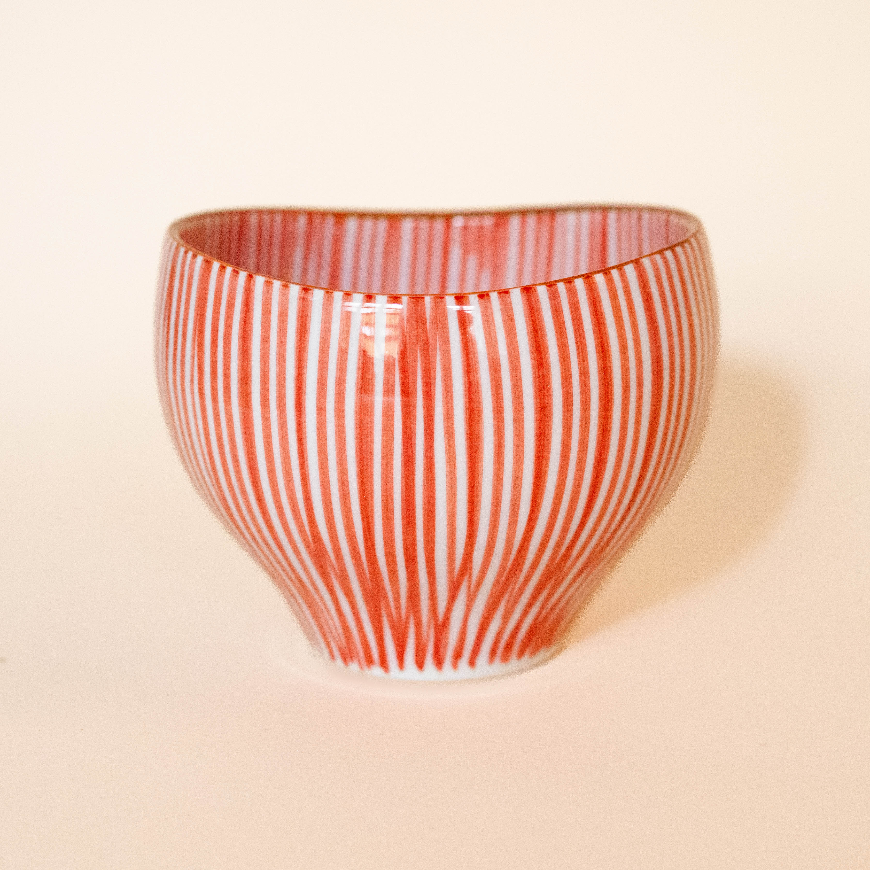 Cup with red vertical stripes and brown rim