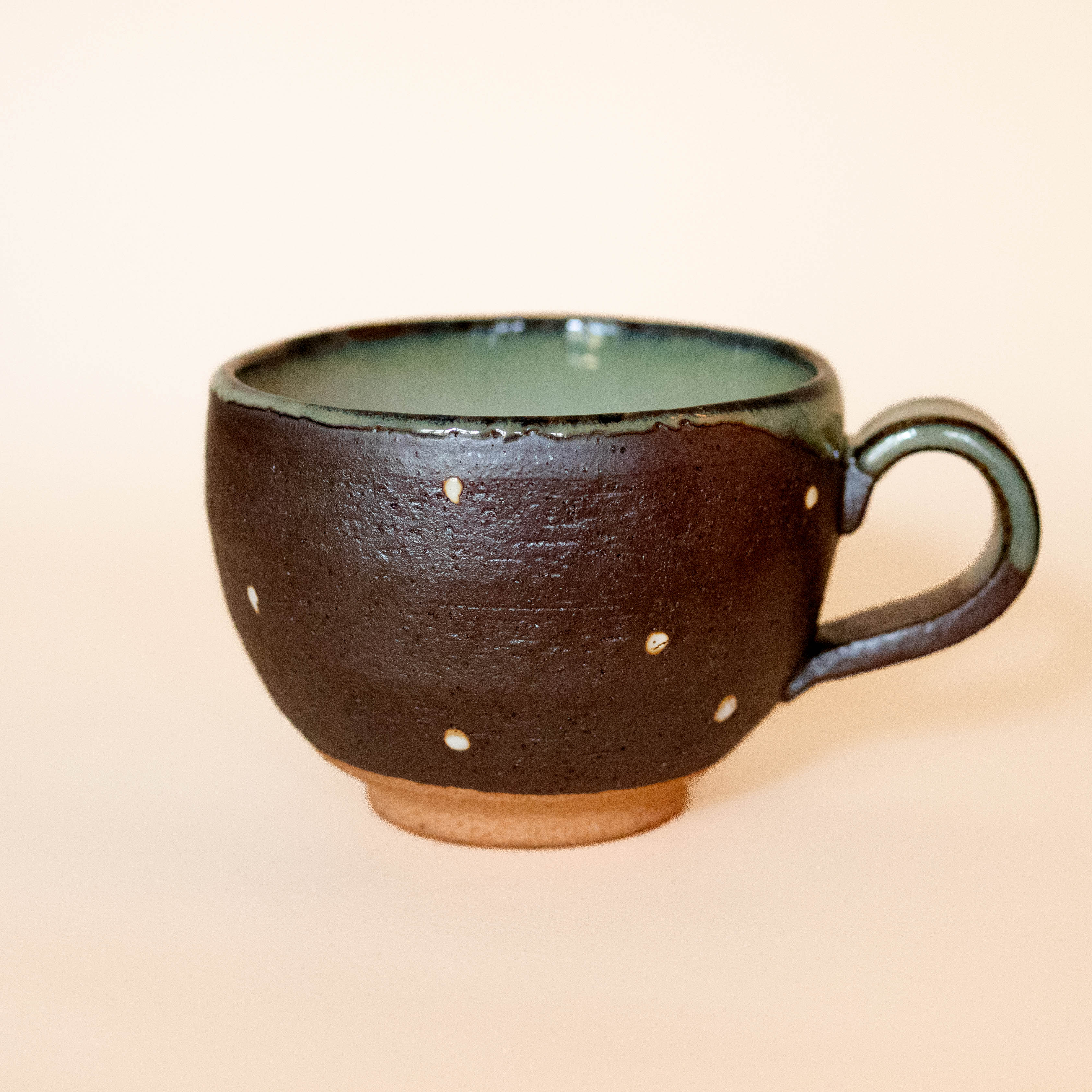 Cup with brown glaze and white dots