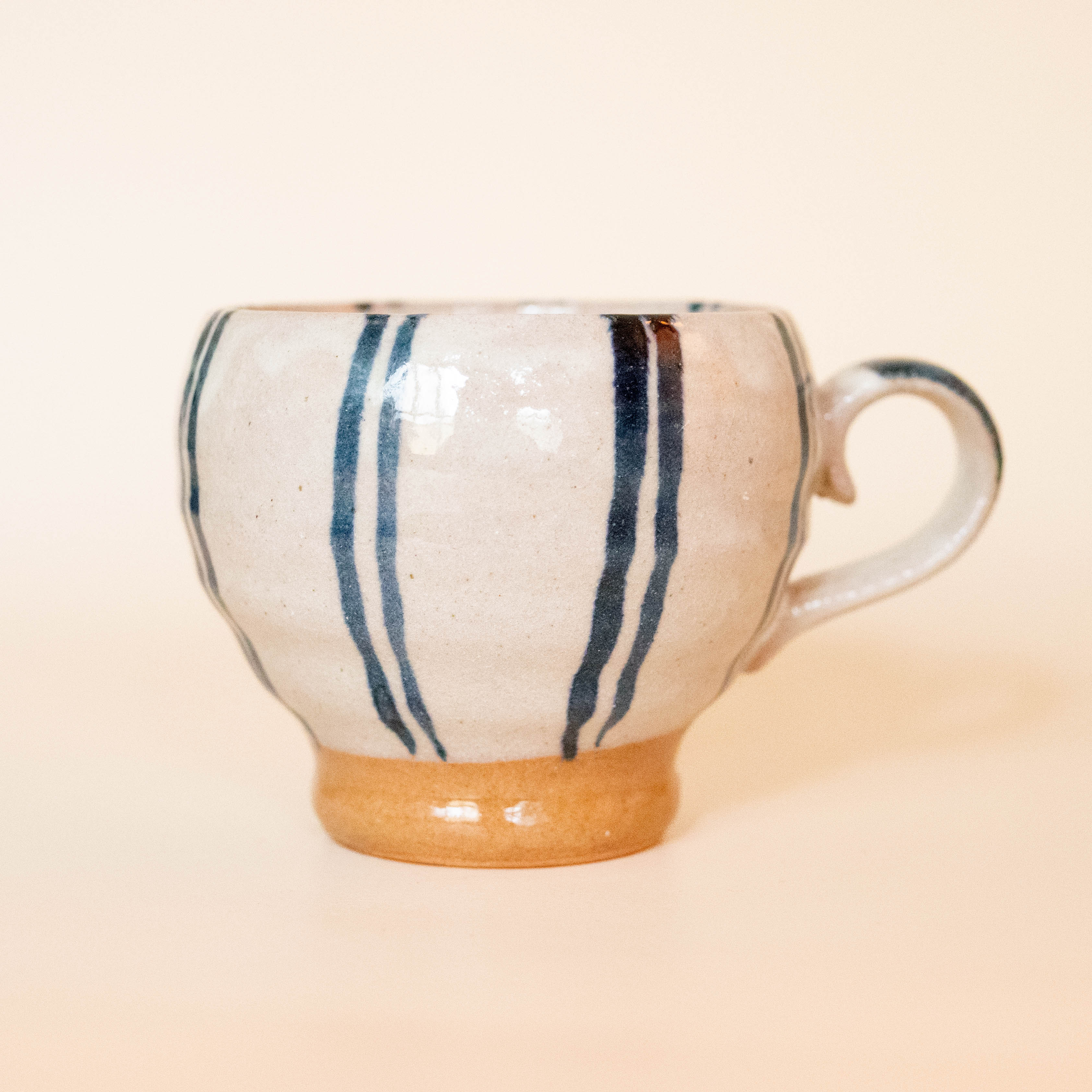 Hand painted ceramic cup with blue stripes