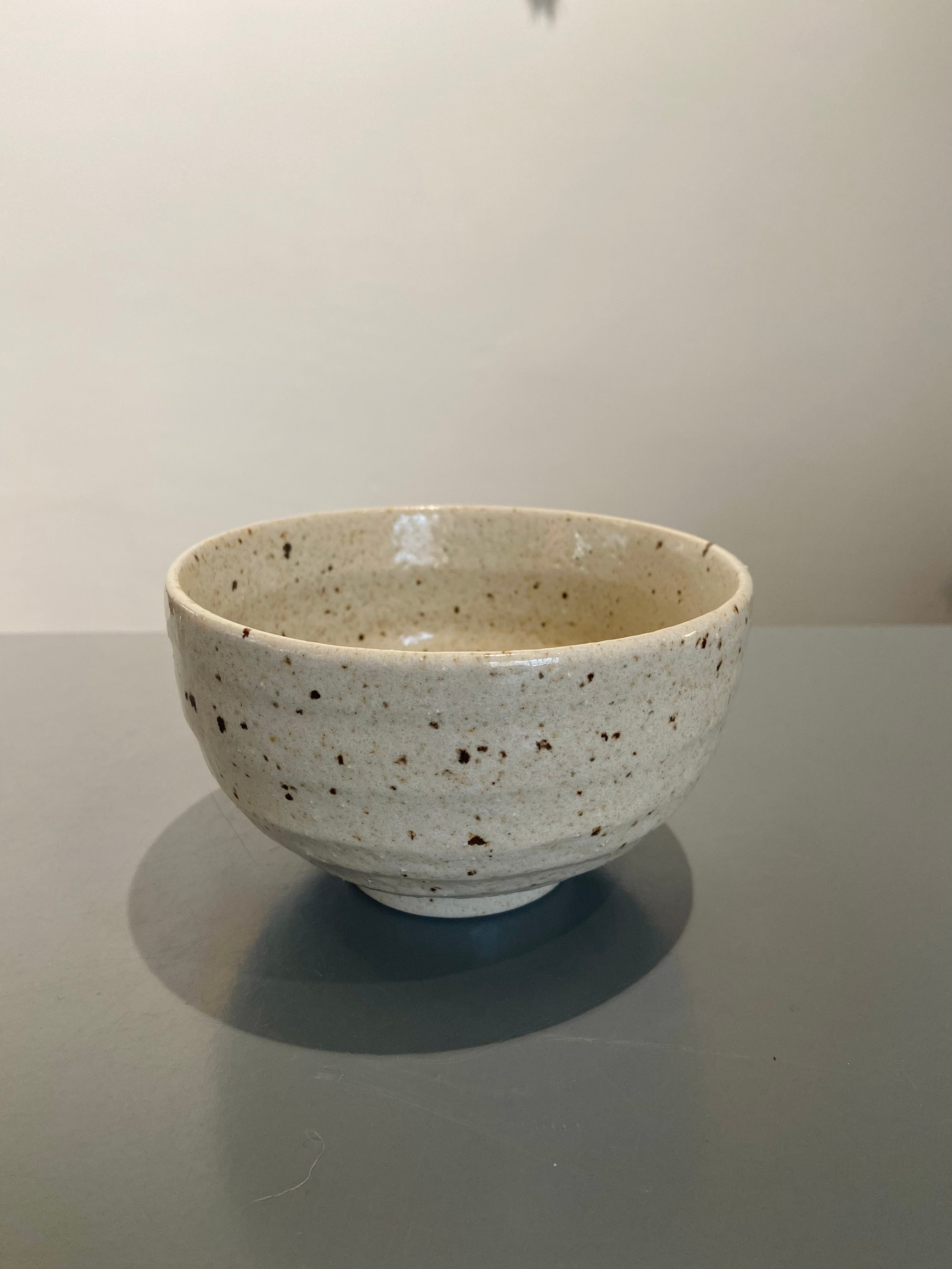 Ceramic bowl with brown chips